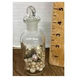 Apothecary bottle with costume pearls