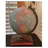 Tabletop Replogle world globe with atlas
