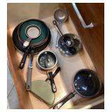 Pots and pans in 2 cabinets under stove