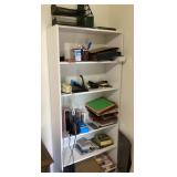 White laminate shelving unit with office supplies.