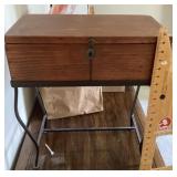 Box with hinged lid on metal stand