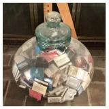 Glass jar filled with matchbooks