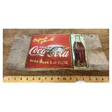 Metal Coca-Cola sign on rough cut board