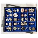 Costume jewelry brooches in riker case
