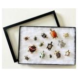 14 turtle brooches in riker case