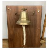 Brass bell mounted on board