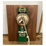 Brass bell mounted on board