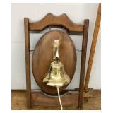 Brass bell mounted on board