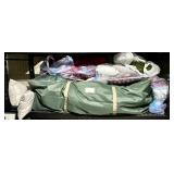 Holiday pillows and bagged Christmas tree