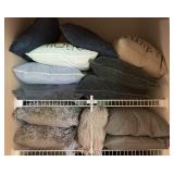 2 shelves of throw pillows in linen closet