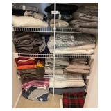 Bottom shelves in linen closet --bed linens