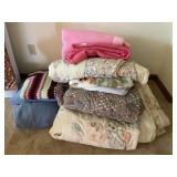 Stack of blankets, afghan, comforters, throws