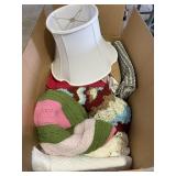Large box of bed and table linens, lamp shade