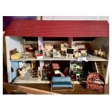 Doll house filled with furniture and dolls