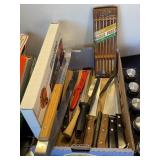 Flat with kitchen knives, fondue forks, etc..