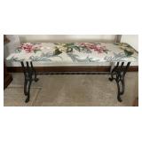 Upholstered bench with cast iron legs
