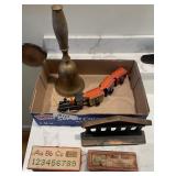 Flat with brass school bell, bookend, erasers,