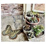 Front porch with plants, rug, wire chair