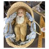 Wicker baby basket with baby doll