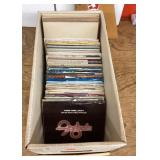 Box of 45 RPM records with picture sleeves