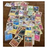 Collection of Pokï¿½mon cards in sleeves