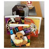 Pokï¿½mon cards in books with collectible tin
