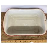 White with red enamelware pan