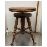 Antique piano stool with glass ball and claw feet
