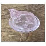 Mini glass cow on nest