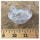 Miniature glass hen on a nest
