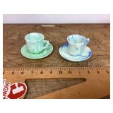 Pair of marbled glass tea, cups, and saucers