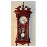 Ornately carved wind-up pendulum wall clock