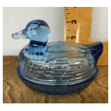 Blue glass duck on a nest