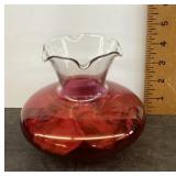Pink vase filled with rose petals