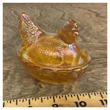 Iridescent amber glass hen on a nest