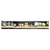 Shelf with pig banks, brass bells, crystal clock