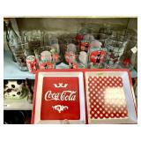 Group of Coca-Cola glasses, tray, and bottle