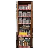 Shelf of media: CDs, DVDs, cassettes, VHS
