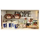 Shelf with Morton Salt mugs, souvenir ashtray,