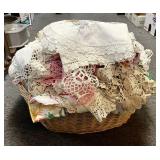 Large stack of doilies and linens in basket