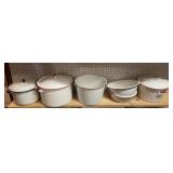 Shelf of white enamelware