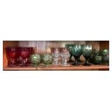 Shelf of colored drinking & sherbet glasses