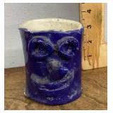 Blue glazed pottery face mug