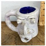 Pottery face mug