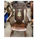 Antique carved face rocking chair