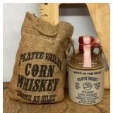Platte Valley corn whiskey jug and burlap bag