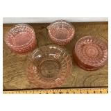 Pink Depression glass bowls and plates