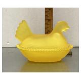Frosted yellow glass hen on a nest