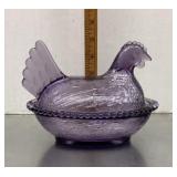 Purple glass hen on a nest
