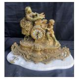 Vintage brass figural mantle clock on marble vase